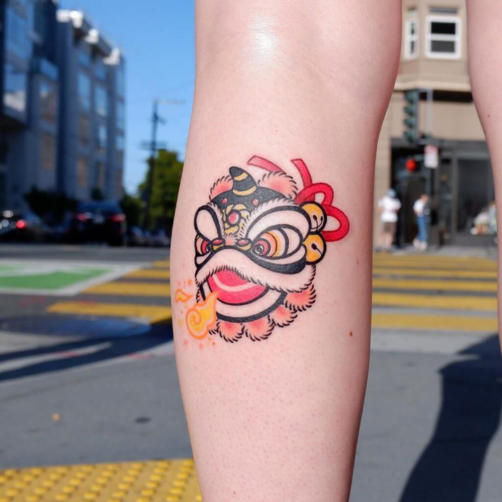 Color tattoo of funny dragon on the calf