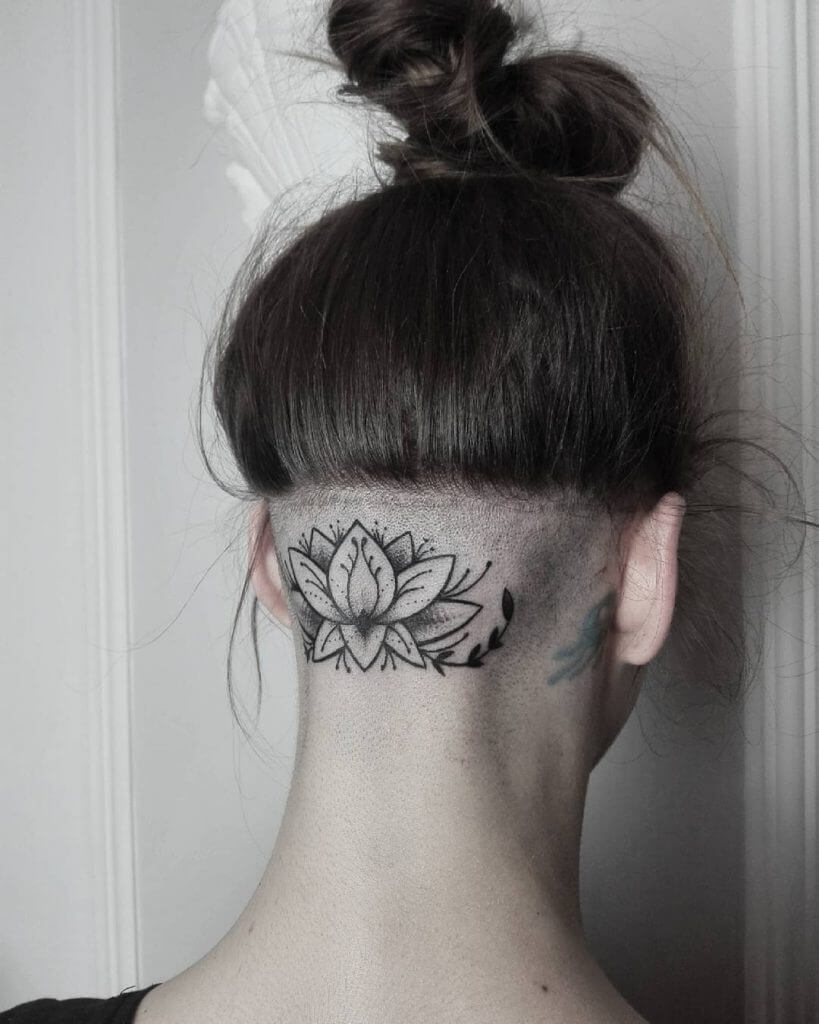 Lotus black tattoo in hair line