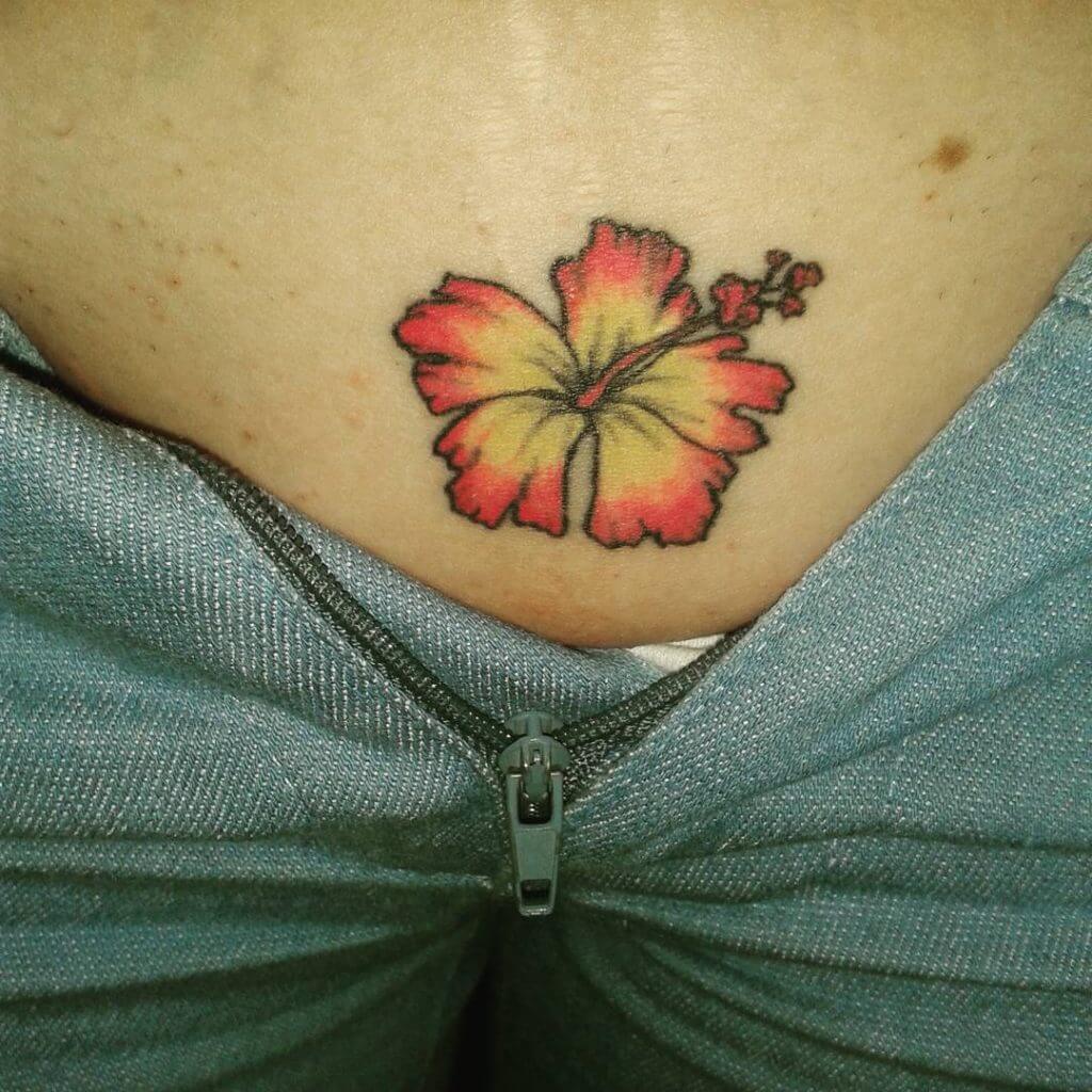 Intimate tattoo of a flower in the pubic zone