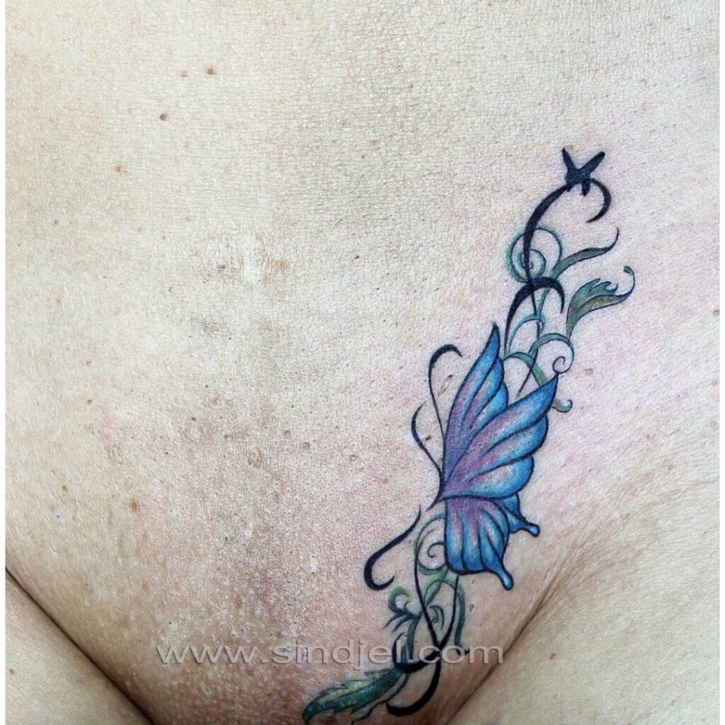 Intimate tattoo of a butterfly in the pubic zone