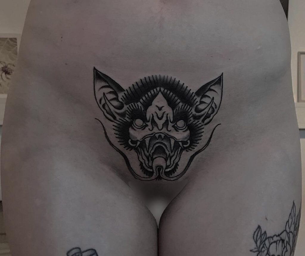 Intimate tattoo of a bat in the pubic zone