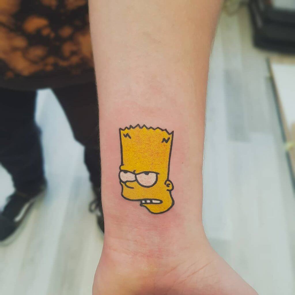Small Cartoon Tattoo of Bart Simpson head on the left forearm