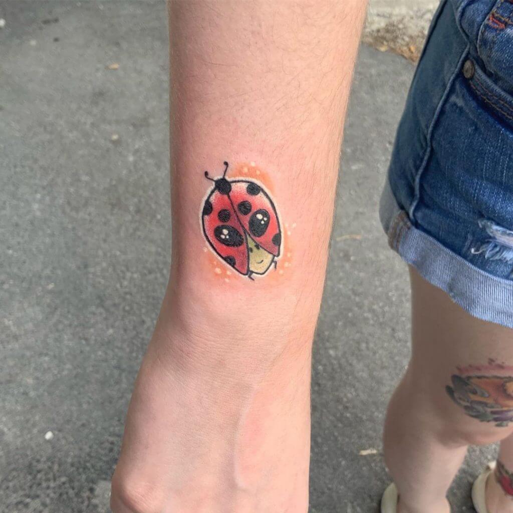 Color Small Cartoon Tattoo of a ladybug on the right forearm