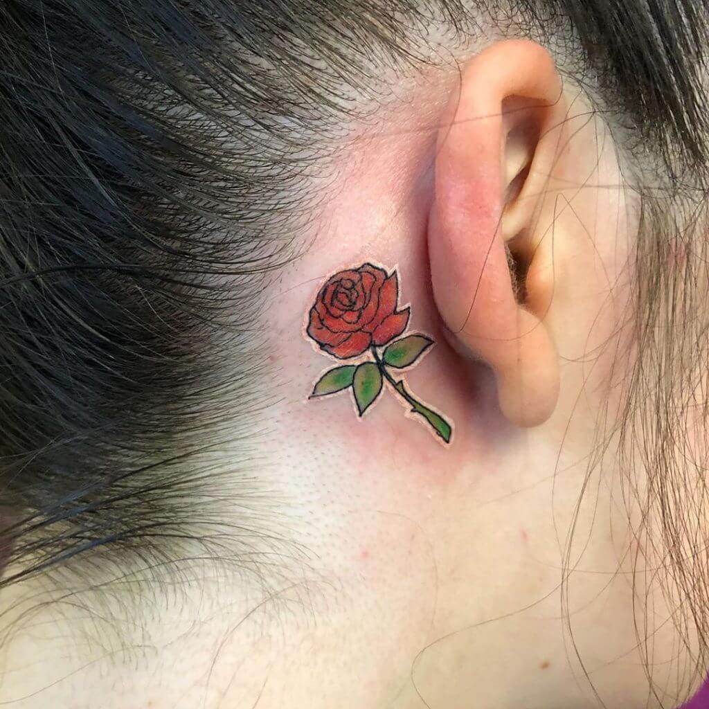 Small Color tattoo of a rose behind the ear