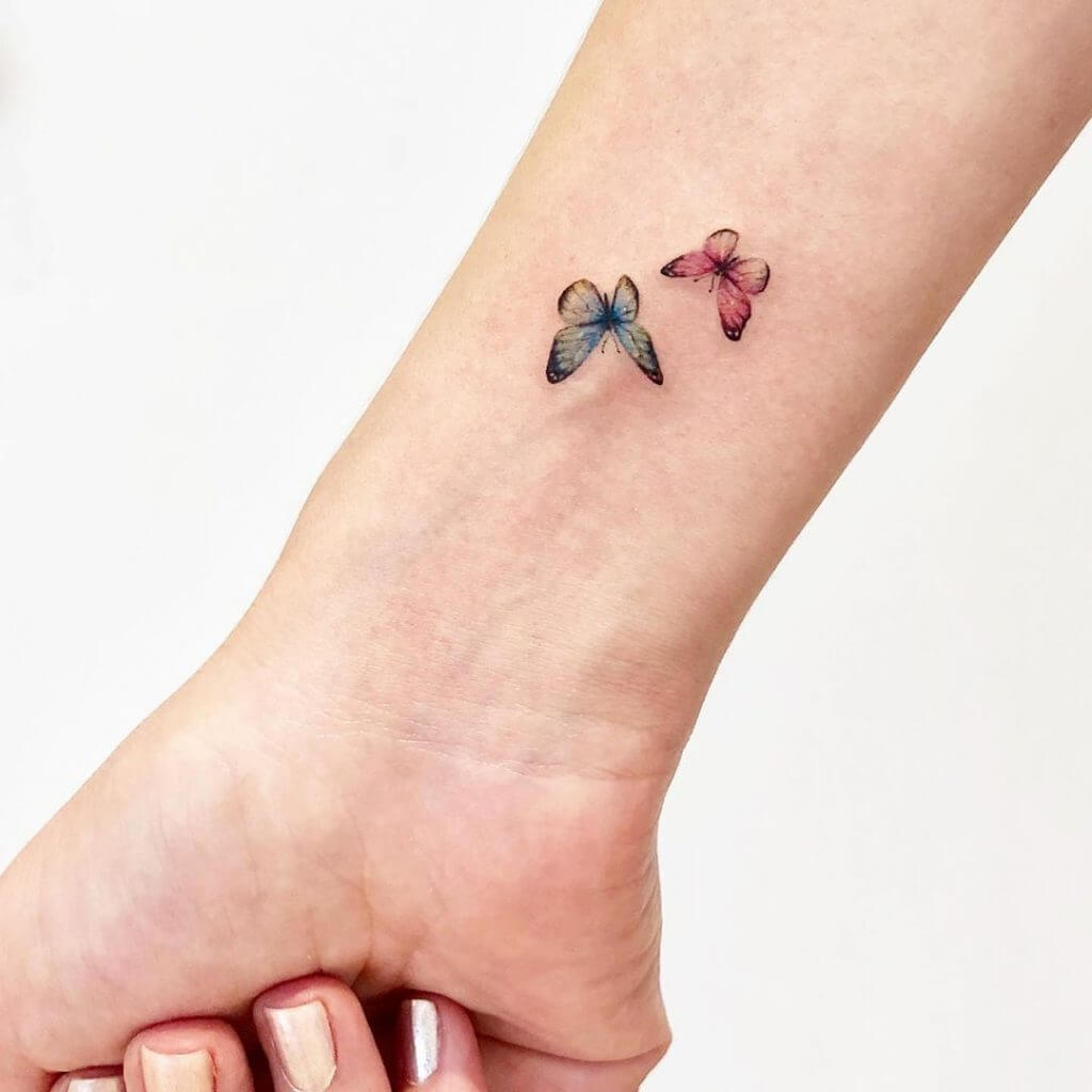 Small Color tattoos of butterflies on the right forearm