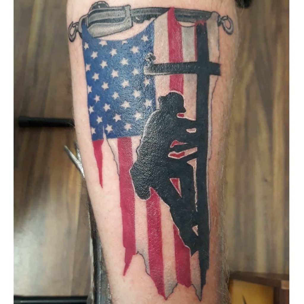 Color tattoo of an American flag and a worker on a calf