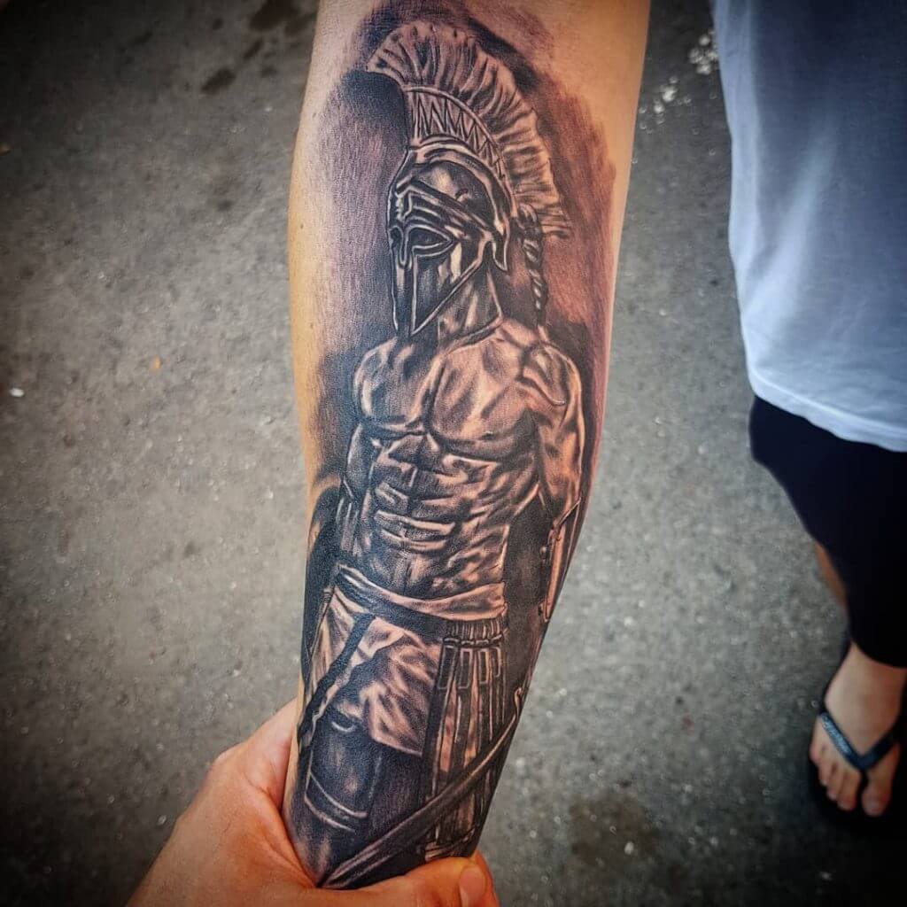 Black and Gray Tattoo of a male Warrior on the right forearm