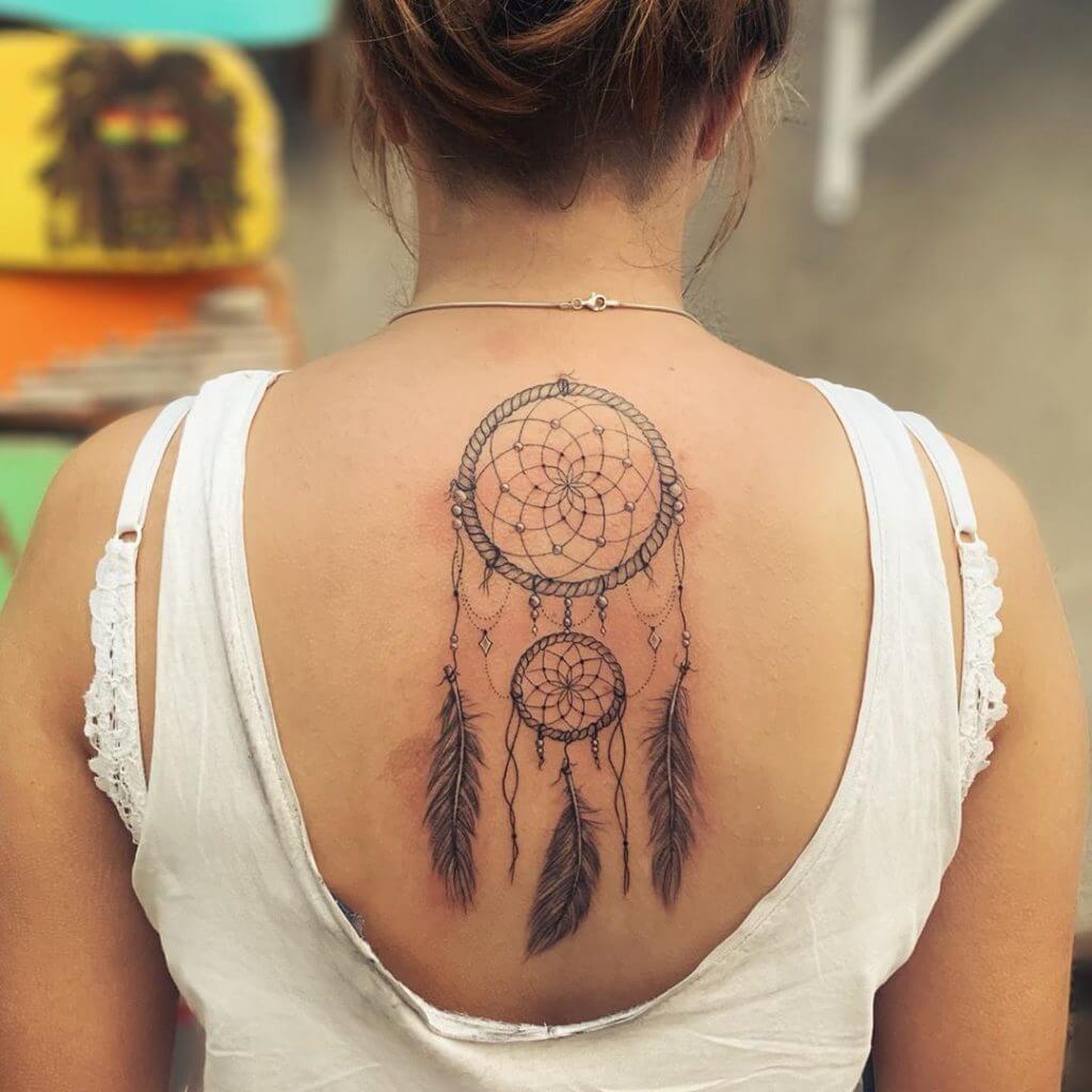 Black Female tattoo of a dreamcatcher on the back