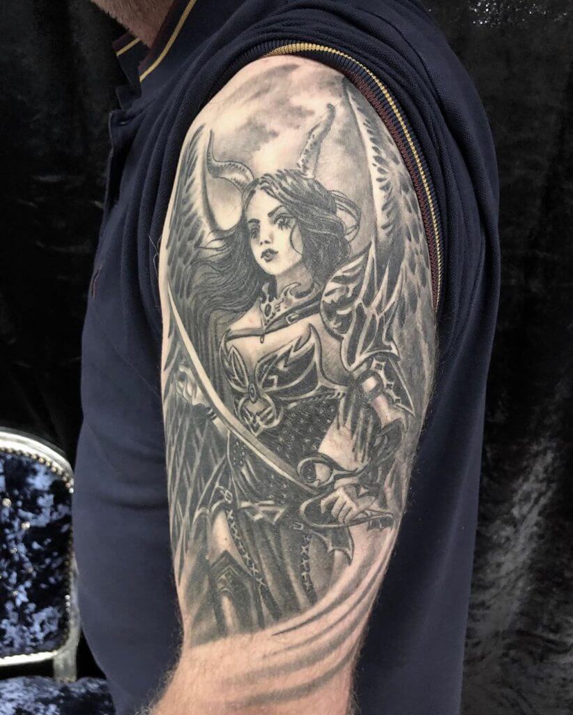 Black Tattoo of a female Warrior on the left shoulder