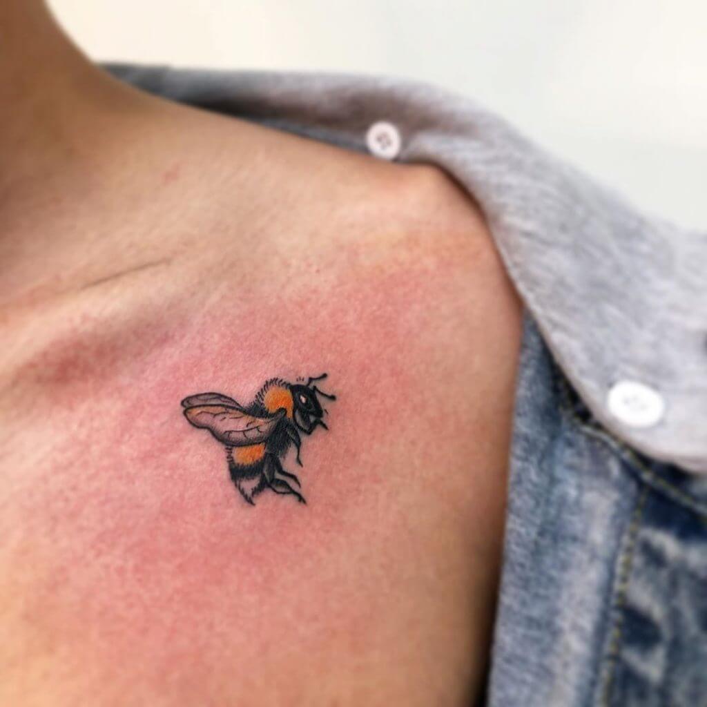 Color Small Cartoon Tattoo of a bee on the left shoulder
