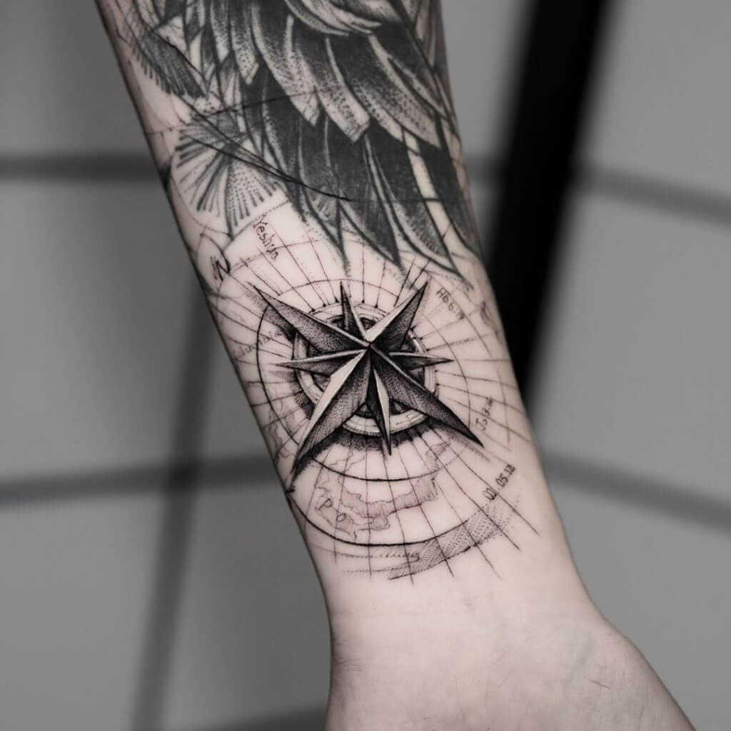 Black Compass tattoo on the left forearm