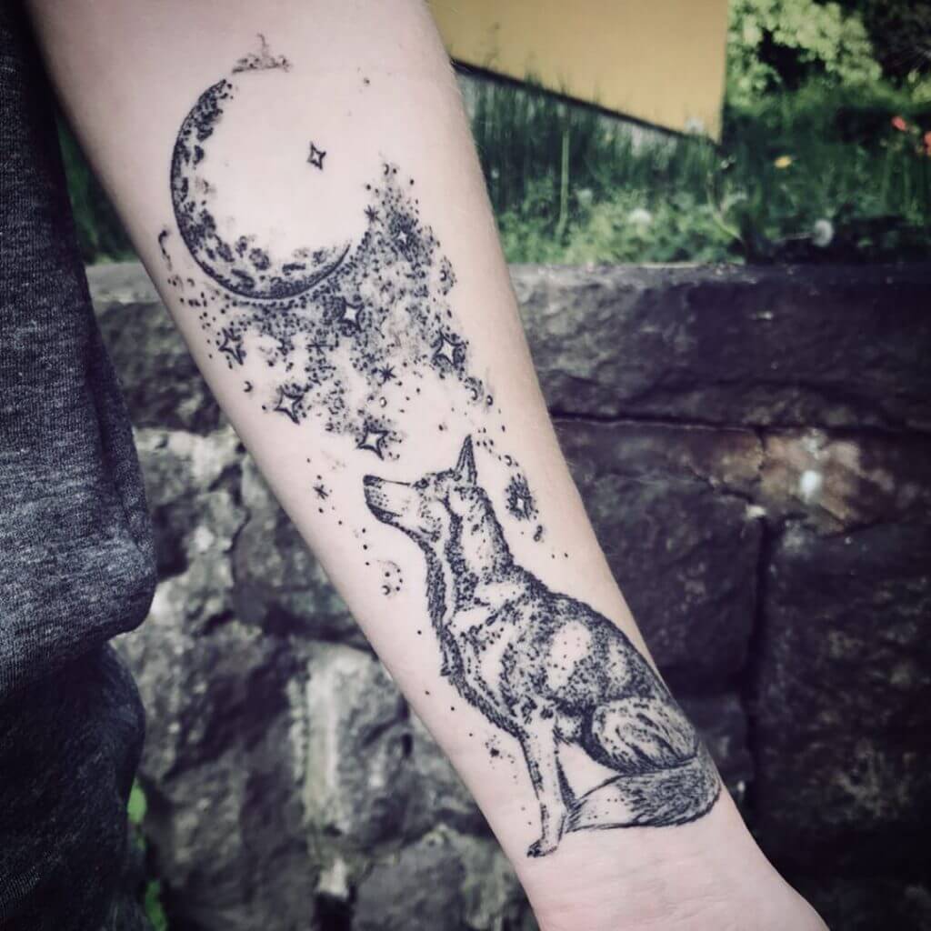 Dot work forearm tattoo of a moon and a wolf