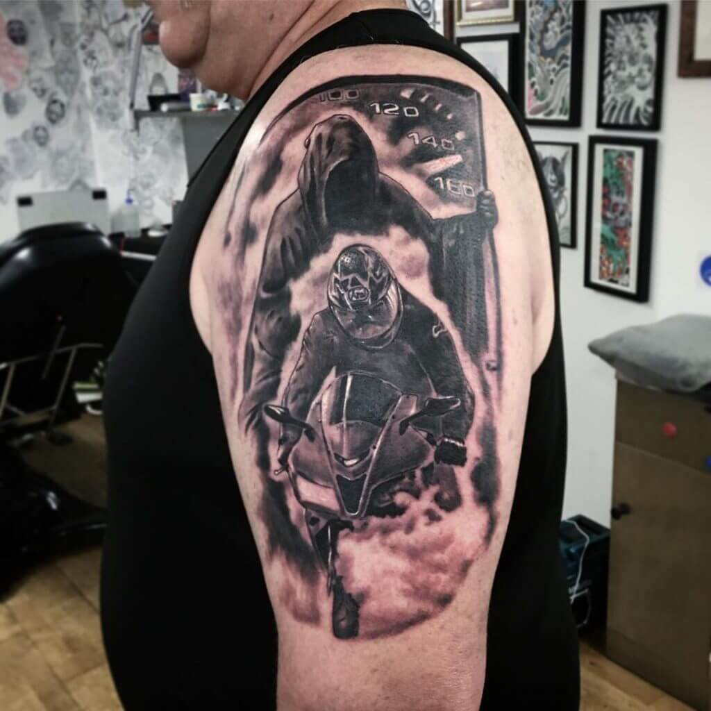 Mens motorbike tattoo of a biker and death on the left shoulder