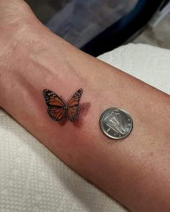 Small 3D Color Butterfly tattoo on the right forearm