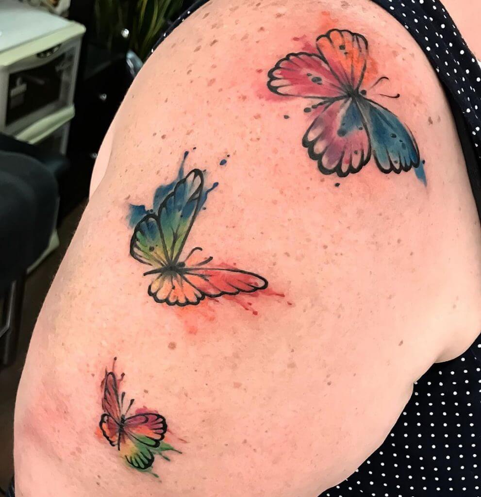 Watercolor Butterfly tattoo on the right arm