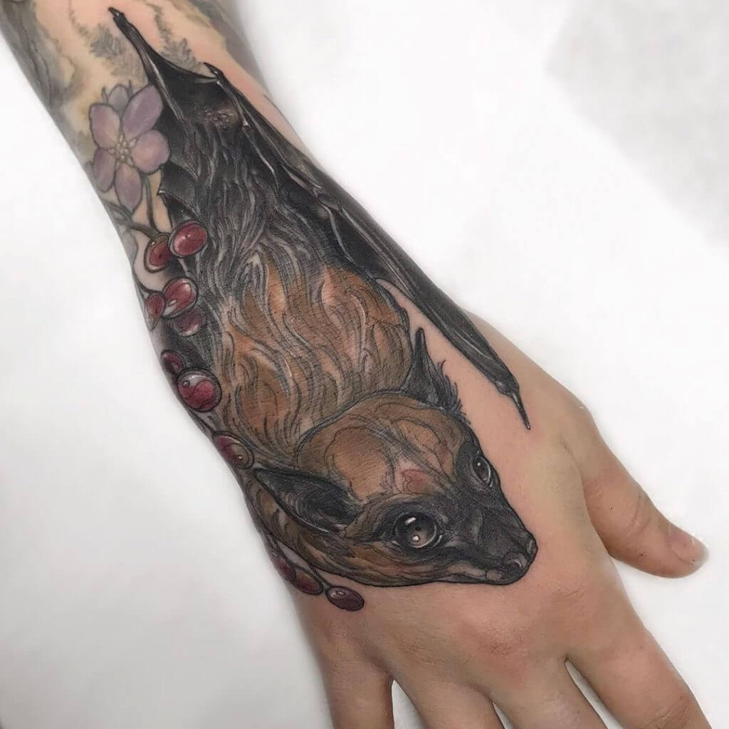 Color Animal tattoo of a bat on the hand