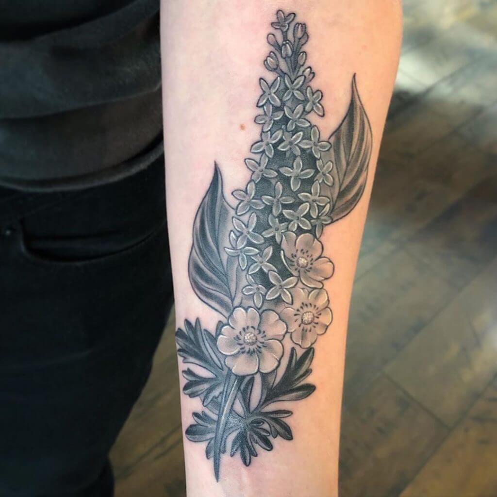 Black Flowers tattoo on the left forearm