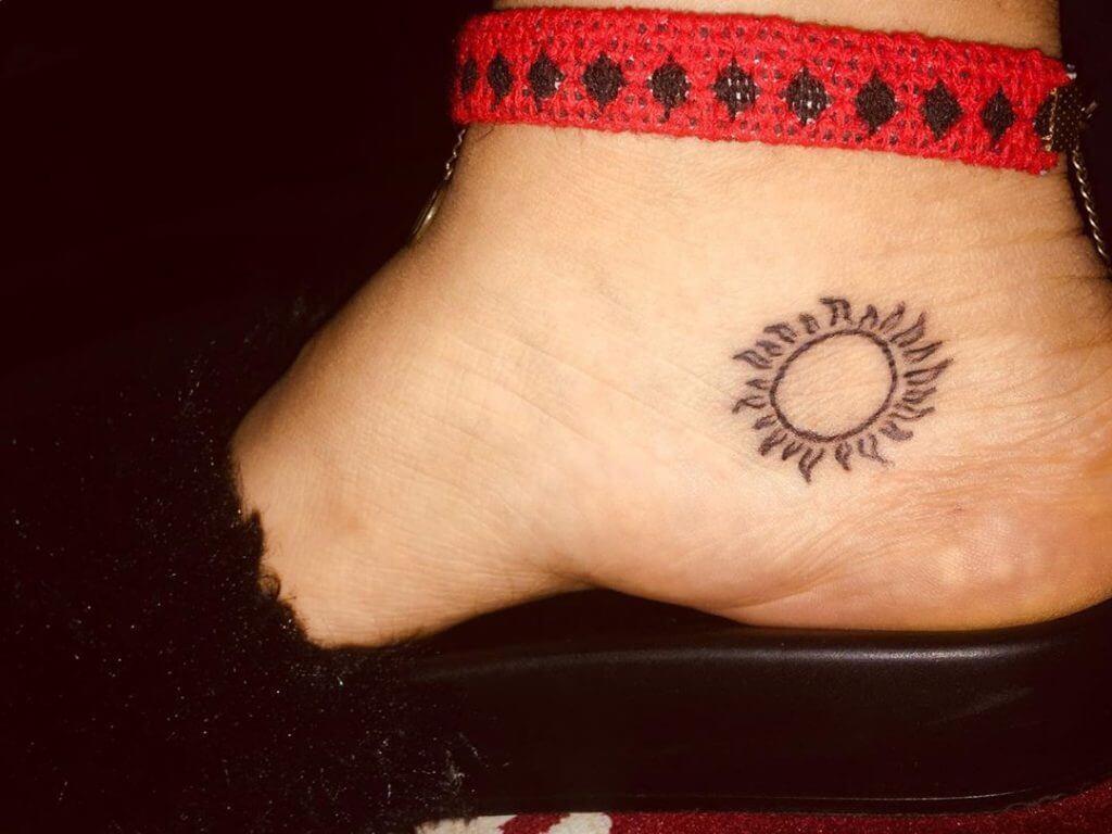 Black Sun tattoo on the foot