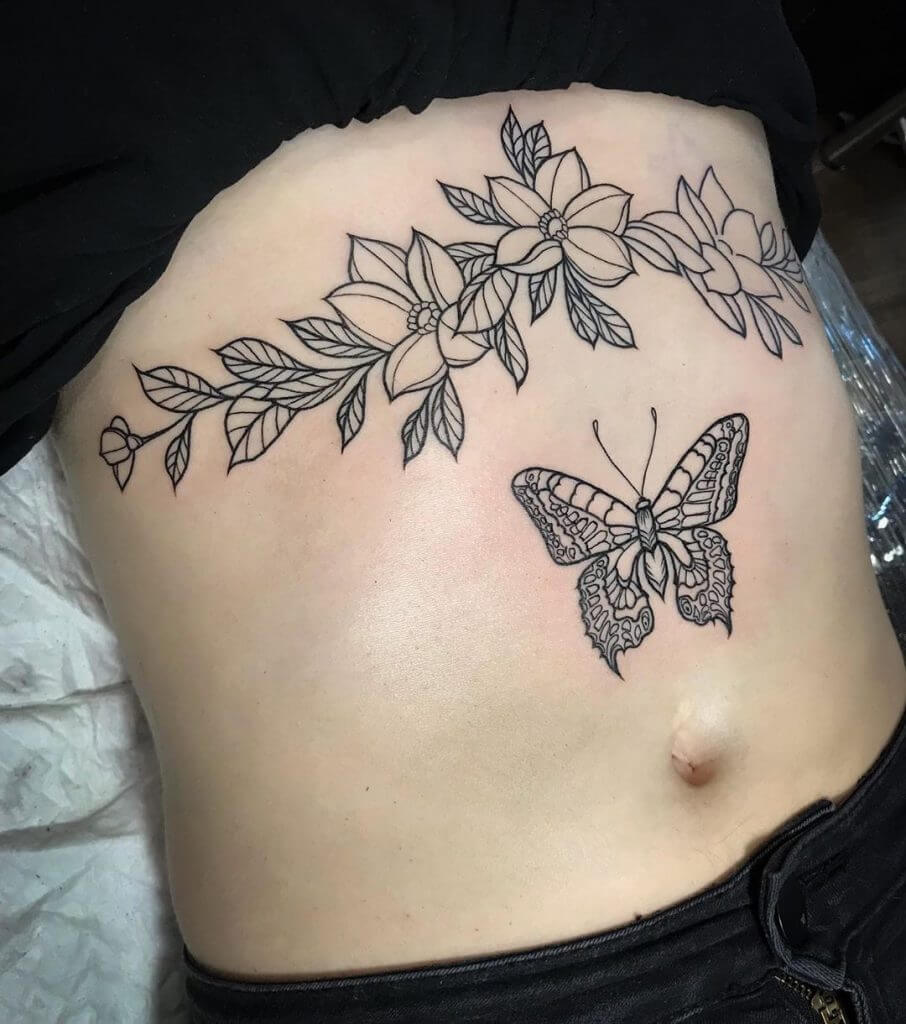 Black Butterfly tattoo with flowers on the belly
