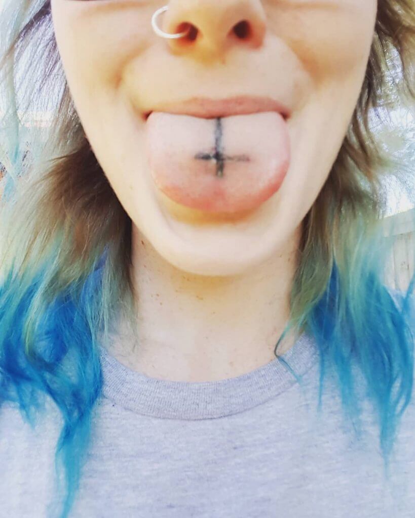 Cross tattoo on the tongue
