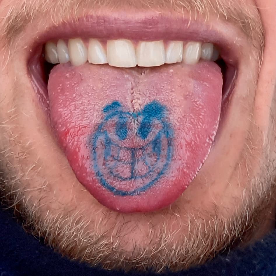Tongue tattoo of a smiley