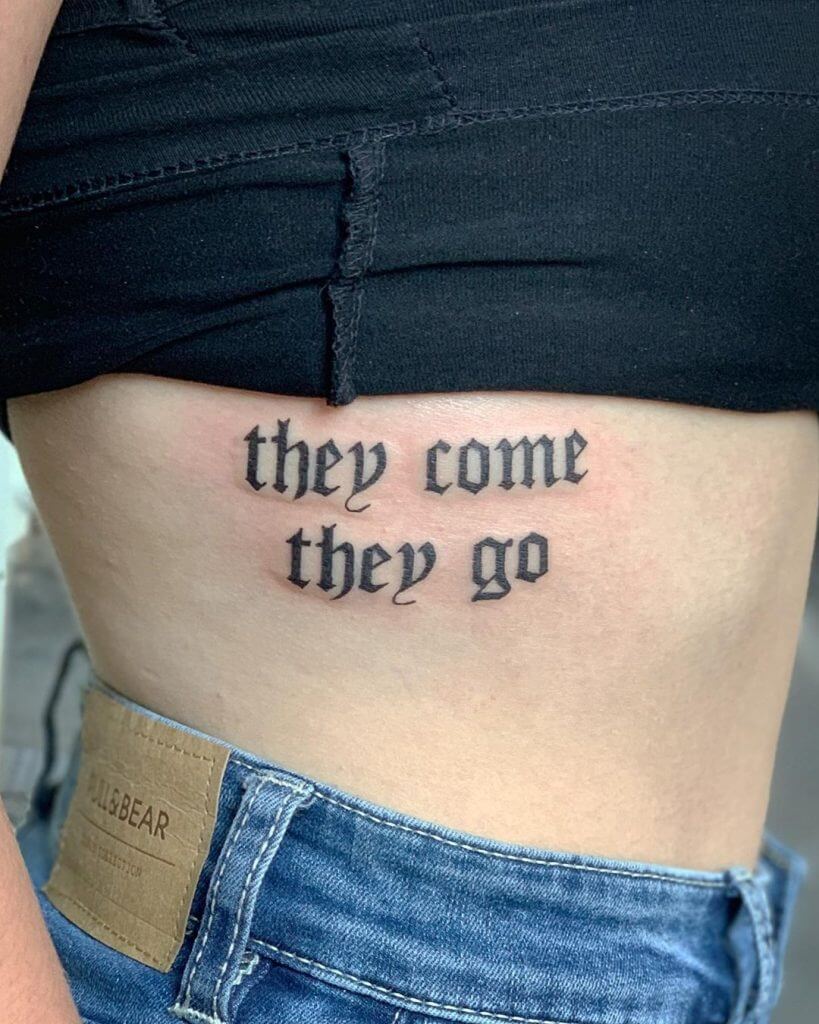 Lettering black tattoo for women of "they come they go" written on the ribs