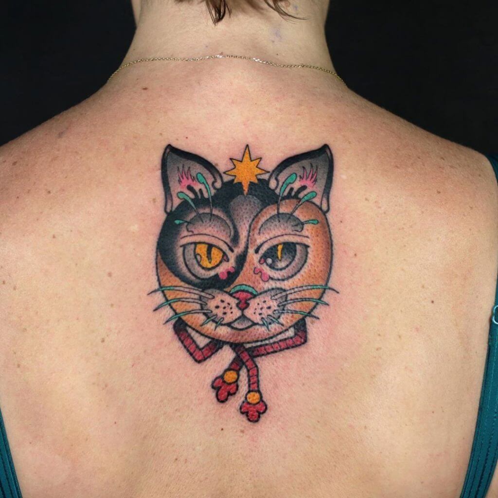 Neo traditional color tattoo for woman of a cat face on the back