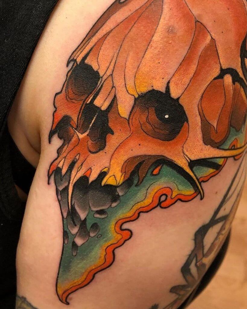 Color neotraditional tattoo of a skull on the left arm