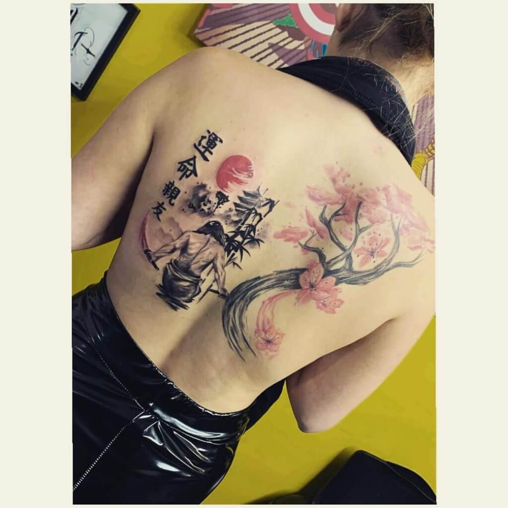 Samurai tattoo on the back with branch sakura tree