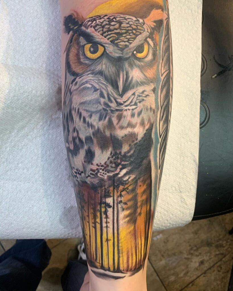 Color owl tattoo with nature for men on the left calf