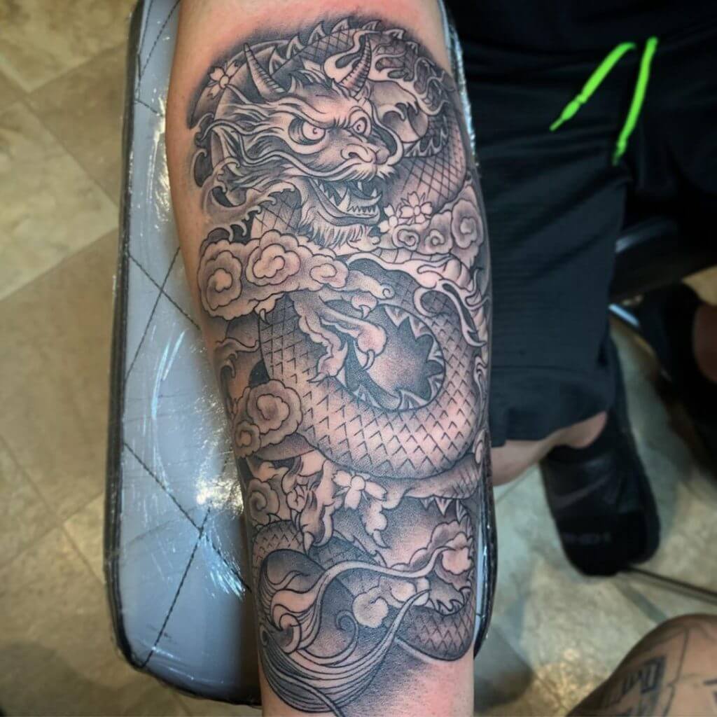 Black dragon tattoo for man on the right forearm