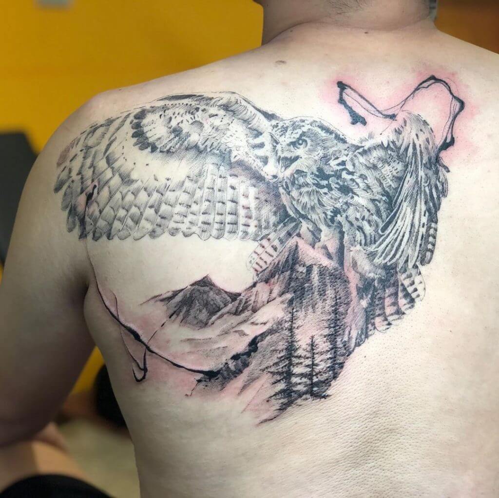Black owl tattoo with mountains for men on the back