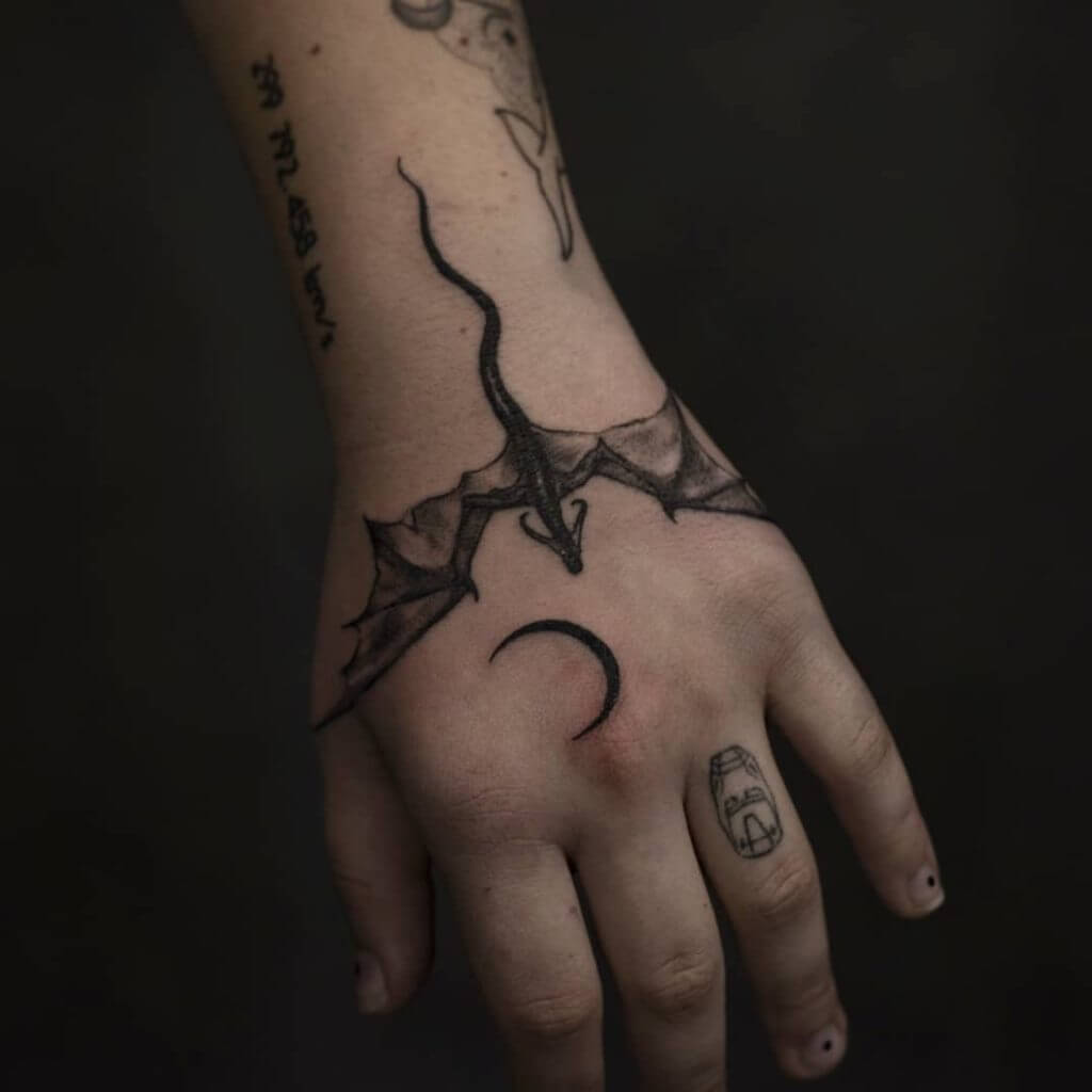 Black dragon tattoo for woman on the left hand