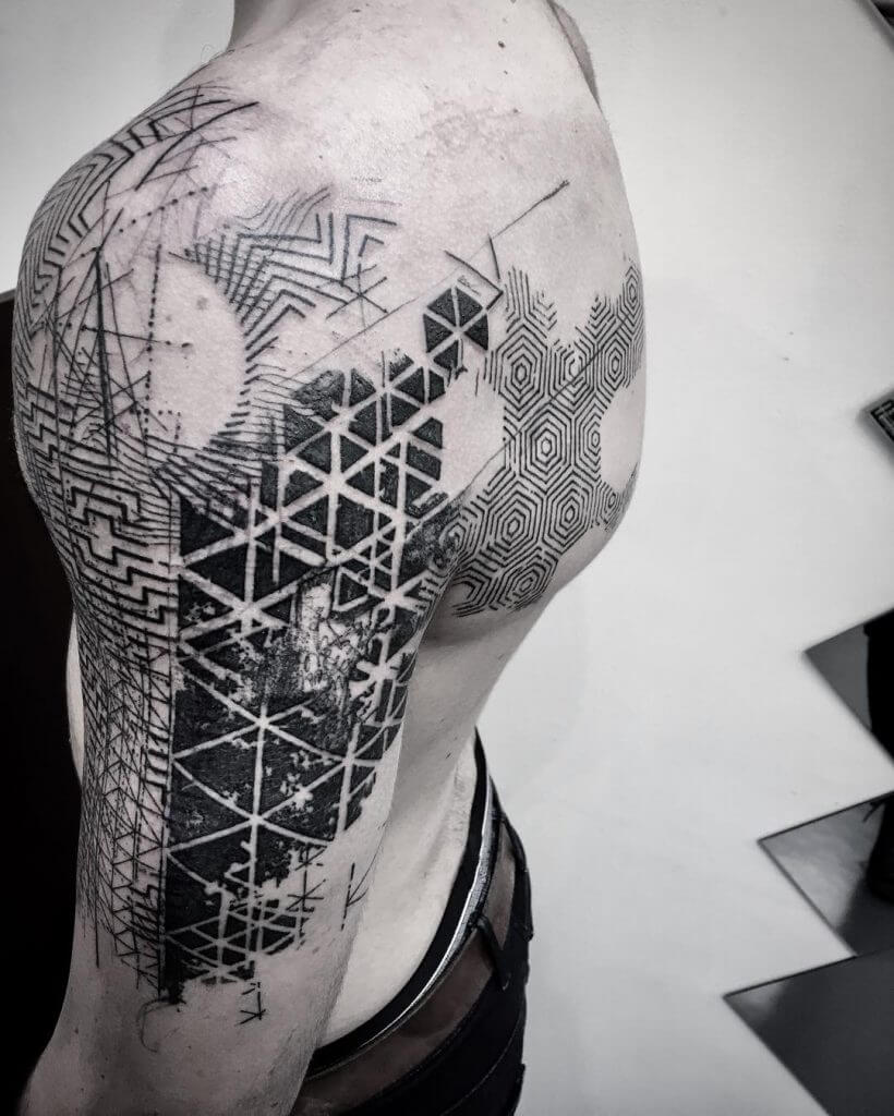 Abstract geometric tattoo on the left shoulder