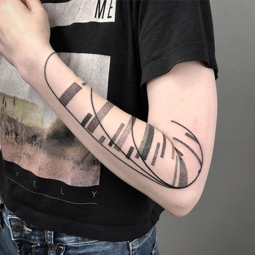 Abstract geometric tattoo on the left forearm