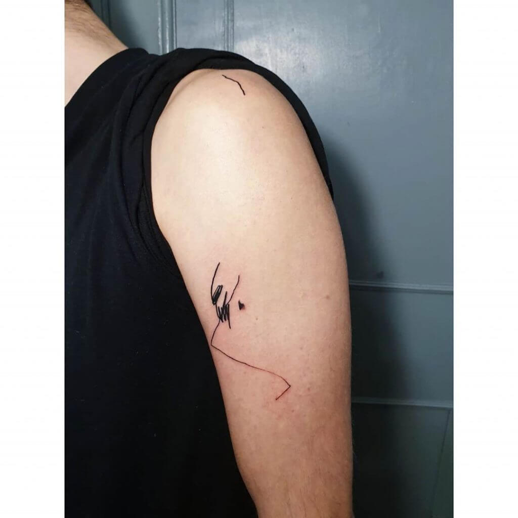 Small abstract tattoo on the left arm