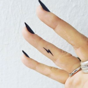 small lightning tattoo on finger