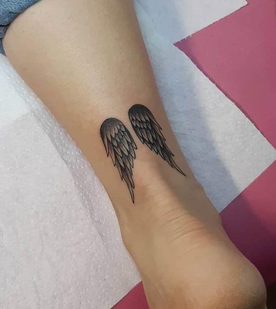 Tiny wing tattoo on the ankle