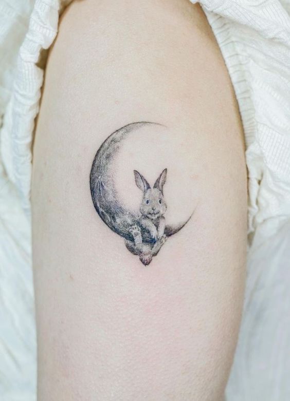 Fine line bunny tattoo forming the word love