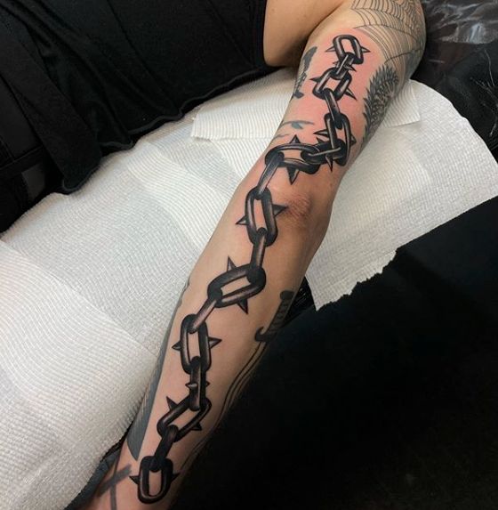chain tattoo wrapped around arm with crossTikTok Search