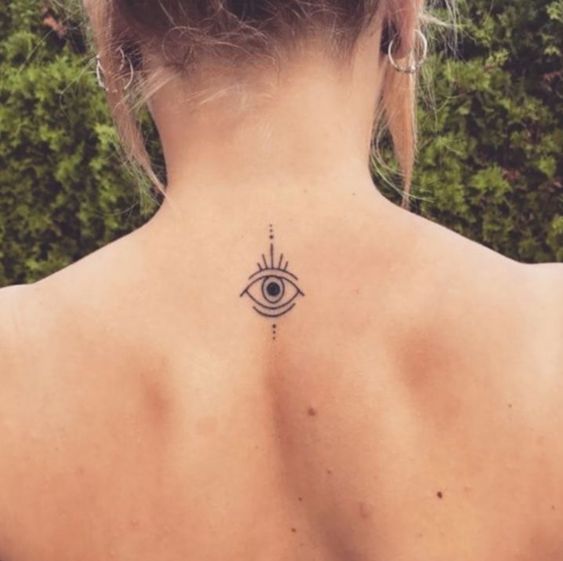 Authentic female evil eye tattoos on back