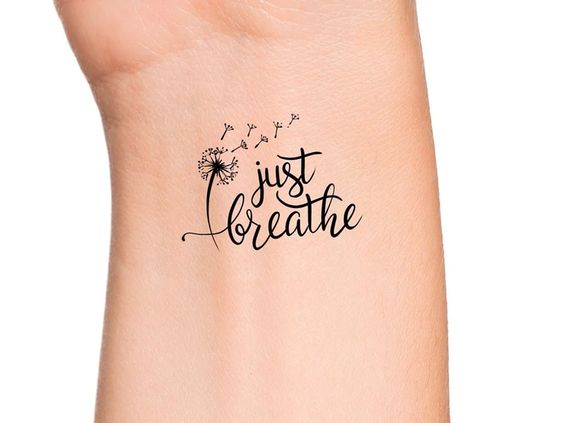 Just breathe tattoo on the wrist