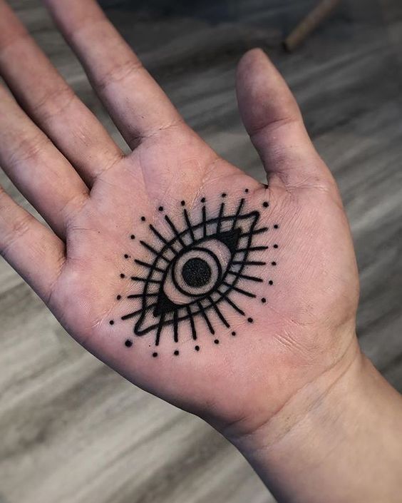 Hand poked evil eye tattoo on the wrist