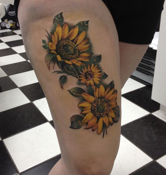 Why not be glamorous and powerful with sunflower thigh tattoo