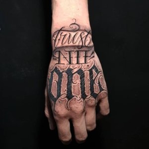 Astonishing designs of Trust no one tattoo on hand 3
