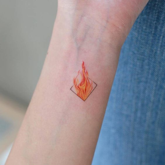 Little fire tattoo on the inner arm