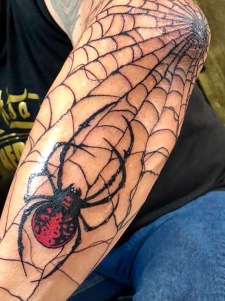 Forearm spider web tattoo with spider