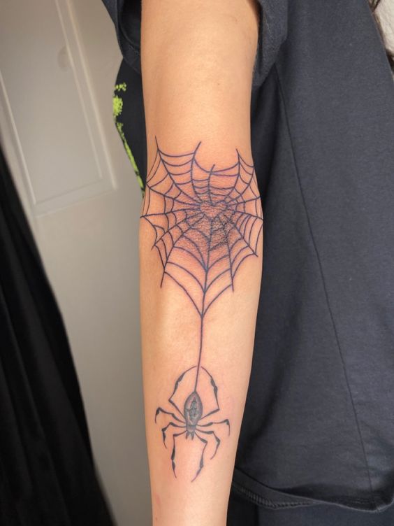 Elbow spider web tattoo with spider
