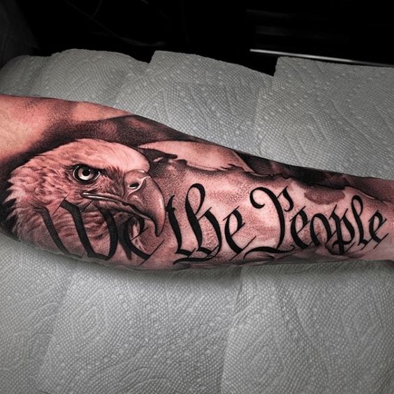 Forearm We the People tattoo with eagle