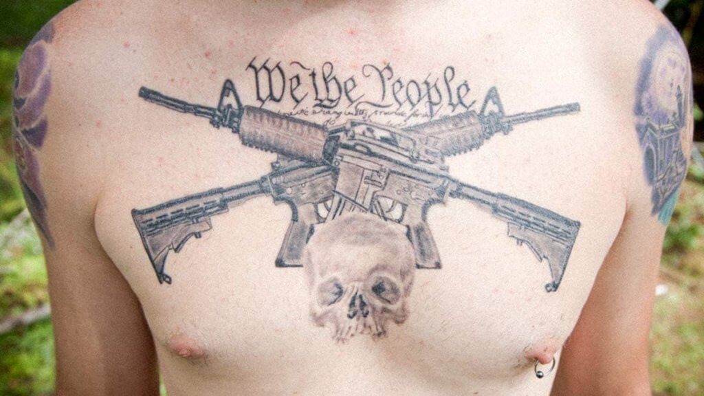 Chest We the People tattoo with a skull and guns